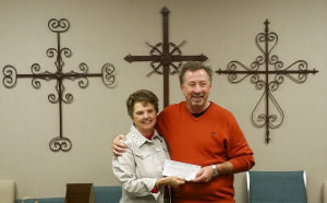 LSFW Board President Virginia Worley presents Pastor Phil Geleske with a check