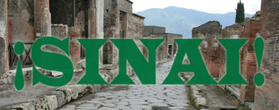 Image of a street paved in stones, lined with old stone buildings. Text over the image reads: ¡SINAI!