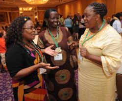 Image of three Black women talking to each other at a reception at the 2014 WELCA Triennial Gathering
