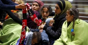 Wellwishers offer warm clothing to Syrians after they arrived on a train from Budapest's Keleti station at the railway station of the airport in Frankfurt, Germany, early morning September 6, 2015. Photo: REUTERS/Kai Pfaffenbach, courtesy of Trust.org